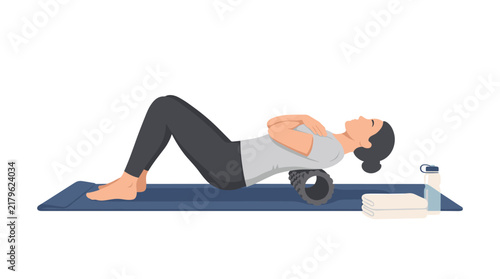 Female athlete using a textured foam roller for back massage and myofascial release on a blue yoga mat