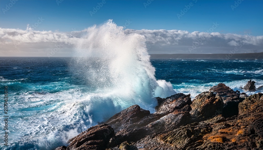 Fototapeta premium majestic ocean waves crashing against rocky coastline