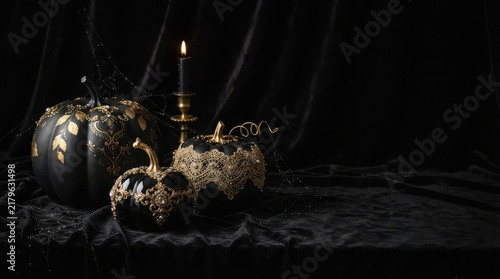 Elegant Black and Gold Halloween Pumpkins with Vintage Candle and Spider Web on Dark Background