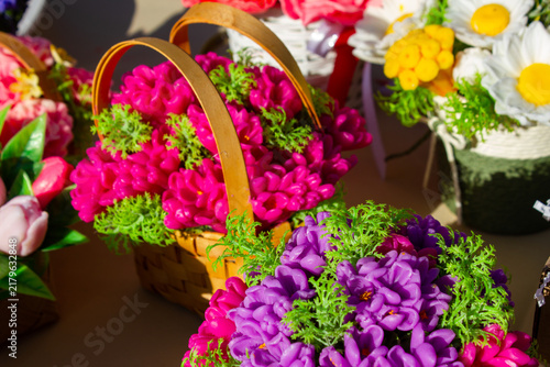 Bright, natural, eco-friendly soap shaped like flowers in a basket. Decorative, souvenir-style shaped soap. Floral-scented soap, a gift. Soap shaped like a bouquet of flowers