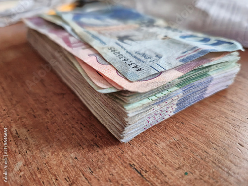Stack of Multicolored Banknotes on Wooden Surface
