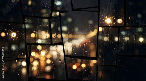 Rainy city night view through a window with blurred lights and reflections