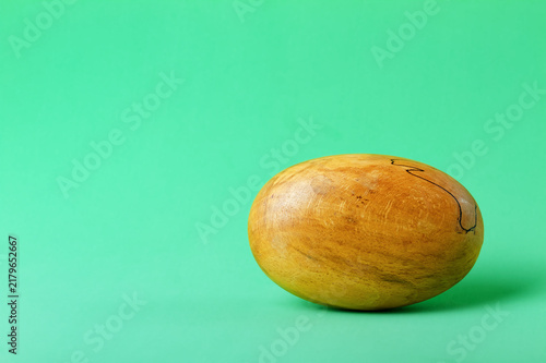 Принти на полотні Polished, Smooth Wooden Egg Shape With Grain Isolated On A Green Background, Min