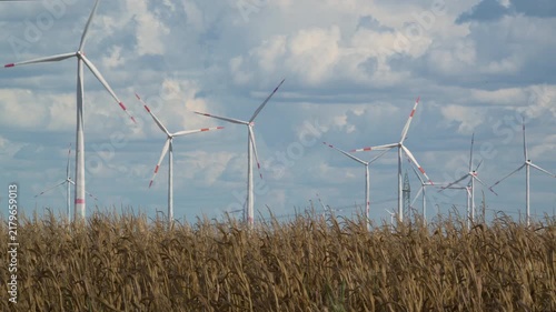 wind turbines in countryside with cornfield in foreground 4K