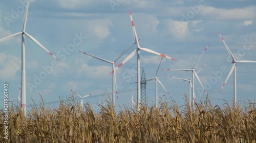 wind turbines in countryside with cornfield in foreground 4K