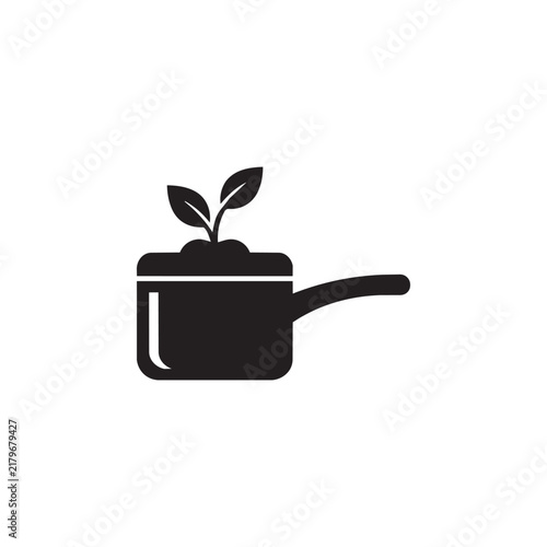 Black and white vector icon of a cooking pot with a sprouting plant representing organic food