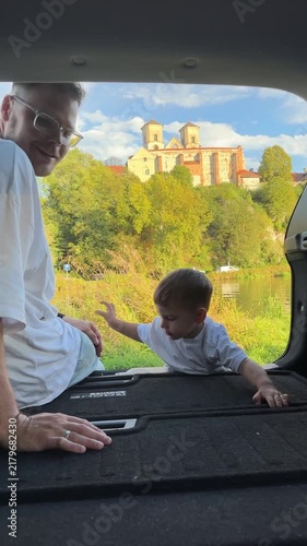 Mother and son watching lake from car
