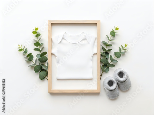 Minimalist framed picture with handwritten notes and small plants on wooden surface