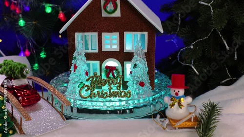 In the Christmas town, among the decorated Christmas trees, there is a small house with Christmas trees and letters