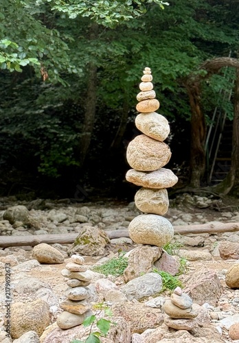 Photography A pyramid of balancing stones on the bank of the river