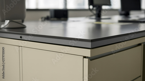 Modern office desk surface with computer monitors and beige storage cabinets computer furniture