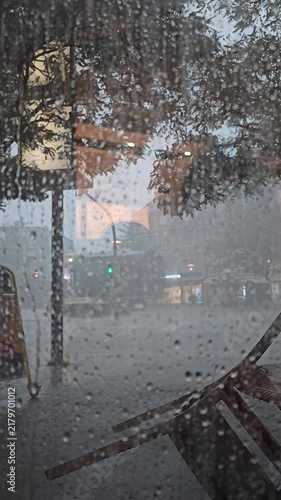 Heavy Rainstorm Over City Street Seen Through Cafe Window