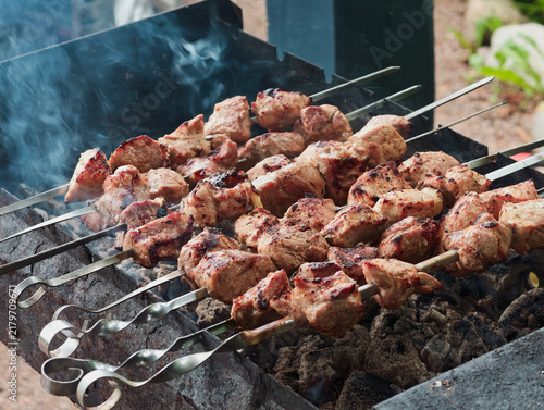 Bild auf Leinwand Crispy traditional pork shashlik grilled on skewers over coals.