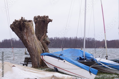 Foto Sailboats stored ashore beside Schwerin Lake during winter