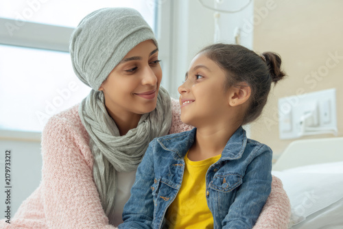 Courageous Young Indian Mother Battling Cancer Embracing Her Young Child Tenderly in Hospital Room