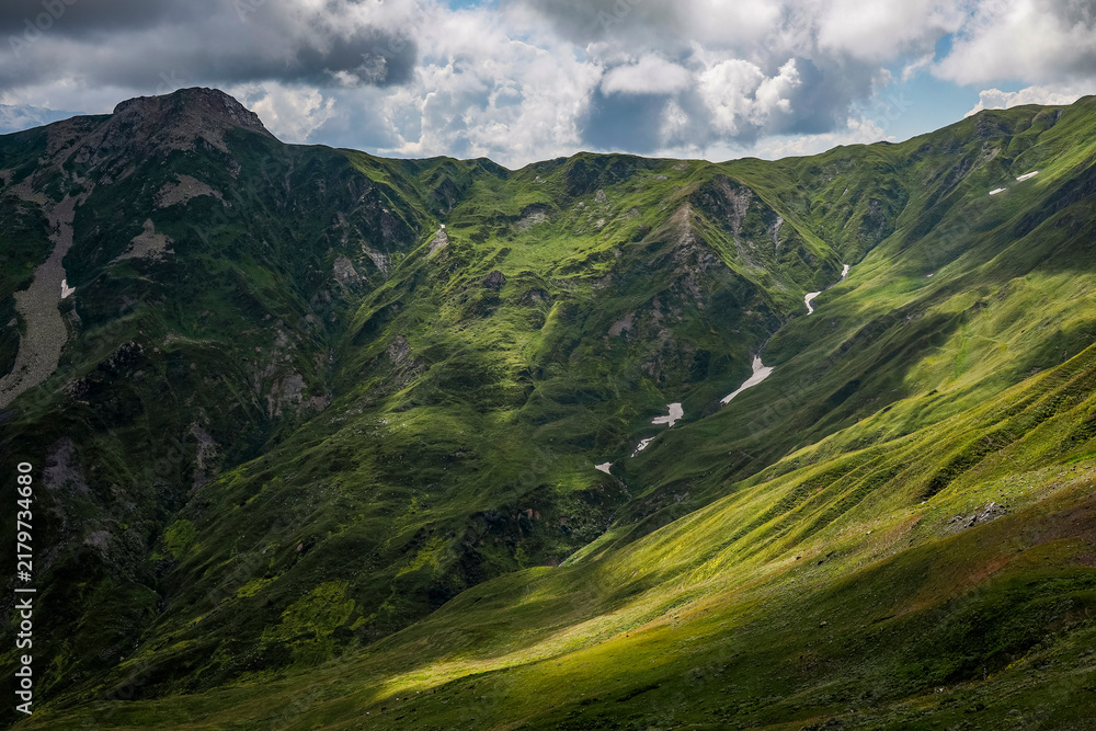 Obraz premium Mountain landscape in Svaneti on cloudy summer day. Caucasus peaks in Georgia. Amazing view on wild georgian nature. 
