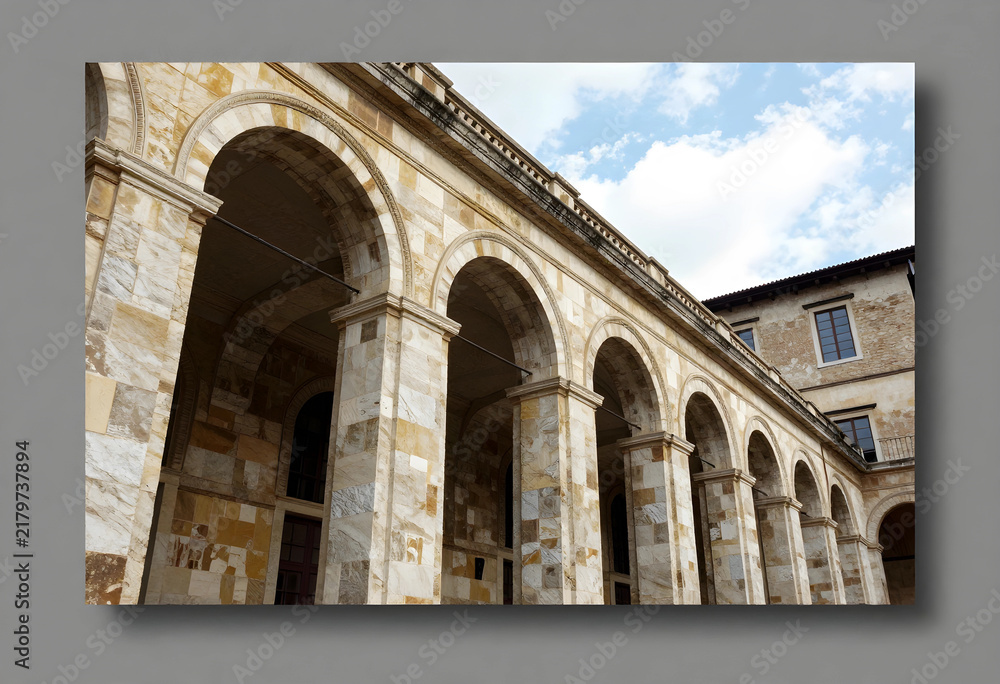 Obraz premium Architectural heritage and historical preservation, stone arcade with marble columns and arched portico of an ancient building under a clear blue sky