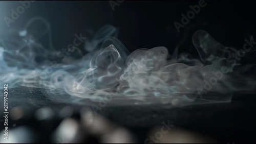 Wispy Gray Fumes Creeping Horizontally on Deep Obsidian Background with Neutral White Mist Tones