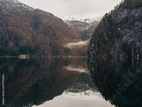 Scenic view of Norwegian fjord with mountain reflection in calm water