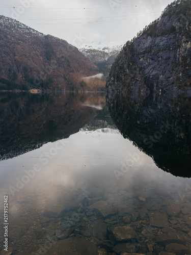 Scenic view of Norwegian fjord with mountain reflection in calm water