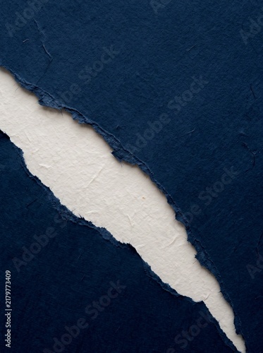 Dark Navy Blue Handmade Paper With Rough Torn Edge Revealing A Bright White Layer Texture Background Concept