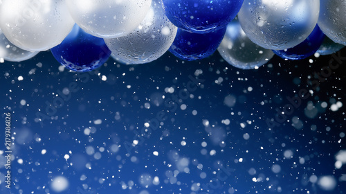 Close-up of hanging blue and silver ornaments against a dark blue gradient background with falling white snow particles.