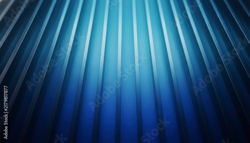 Abstract blue background with vertical lines and glowing light effect