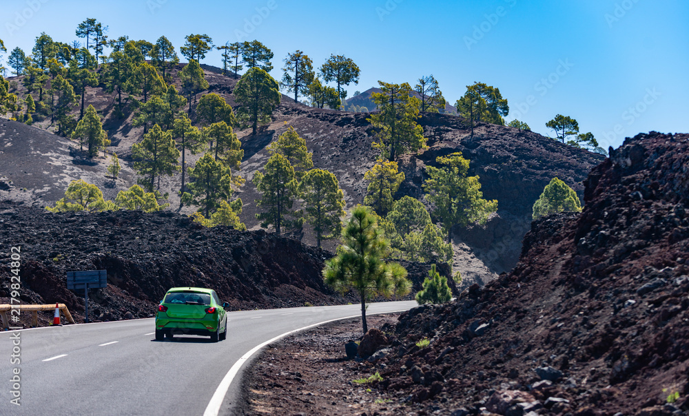 Obraz premium Tenerife travel reveals volcanic scenery. Tenerife mountain landscape frames scenic highway. Rugged Tenerife geology enriches adventure. Tenerife destination rewards exploration.