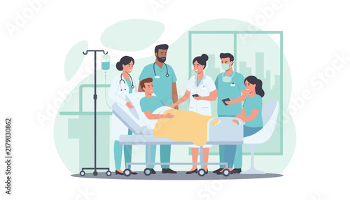 Diverse medical team of doctors and nurses providing care and support for a male patient lying in a hospital bed in a modern clinic room.