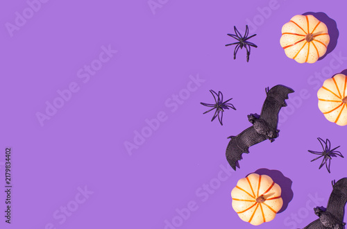 Bild auf Leinwand Pastel yellow pumpkin, spider and bat on a bright purple background