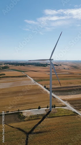 Renewable energy and sustainability, aerial drone view of a wind turbine in a rural agricultural field, clean power generation and climate change