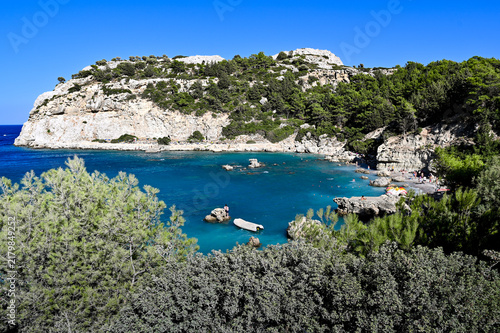 Rocky Mediterranean cove with turquoise water and pine-covered cliffs - Anthony Quinn's Bay, Rhodos Island, Greece
