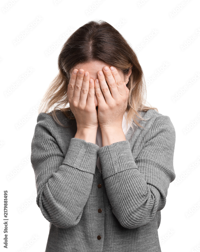 Fototapeta premium Stressed woman covering face with hands on white background