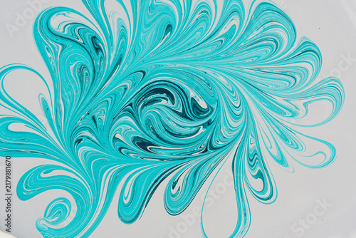 Abstract floral ebru paint pattern in turquoise and teal colors isolated on white background.