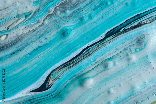 Smooth diagonal streams turquoise, white, and black paint creating marble liquid background.