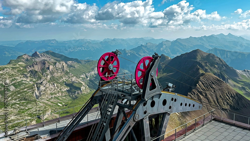 Quadro su tela Alpine Cableway Machinery Above Rugged Mountain Landscape