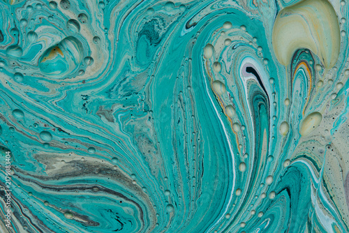 Vibrant turquoise acrylic paint with swirling marble lines and tiny bubble textures.