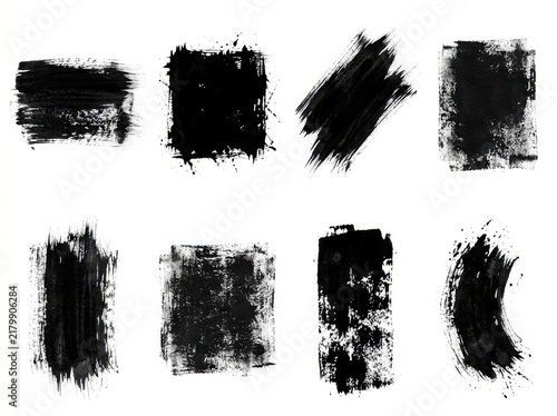 Set of eight black ink brush strokes and artistic paint textures for design