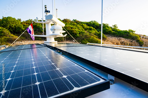 Foto Large solar panels covering the deck of a modern yacht with marine navigation eq