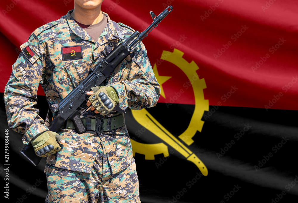 Obraz premium Angola flag with soldier holding assault rifle