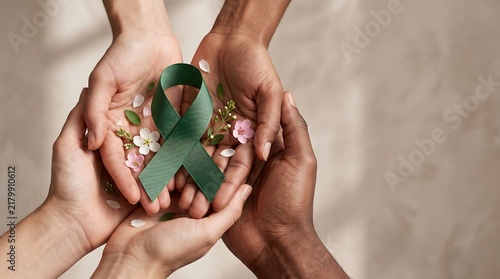 Diverse Hands Holding Green Awareness Ribbon with Flowers for Mental Health and Liver Cancer Support Campaign Background
