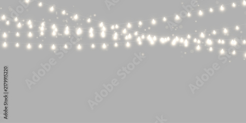 Bild auf Leinwand Strings of glowing bulbs emit soft warm light across a dark background