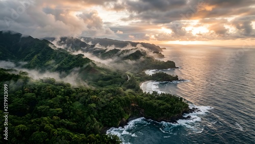 Misty mountains and ocean coastline at sunrise with dramatic clouds
