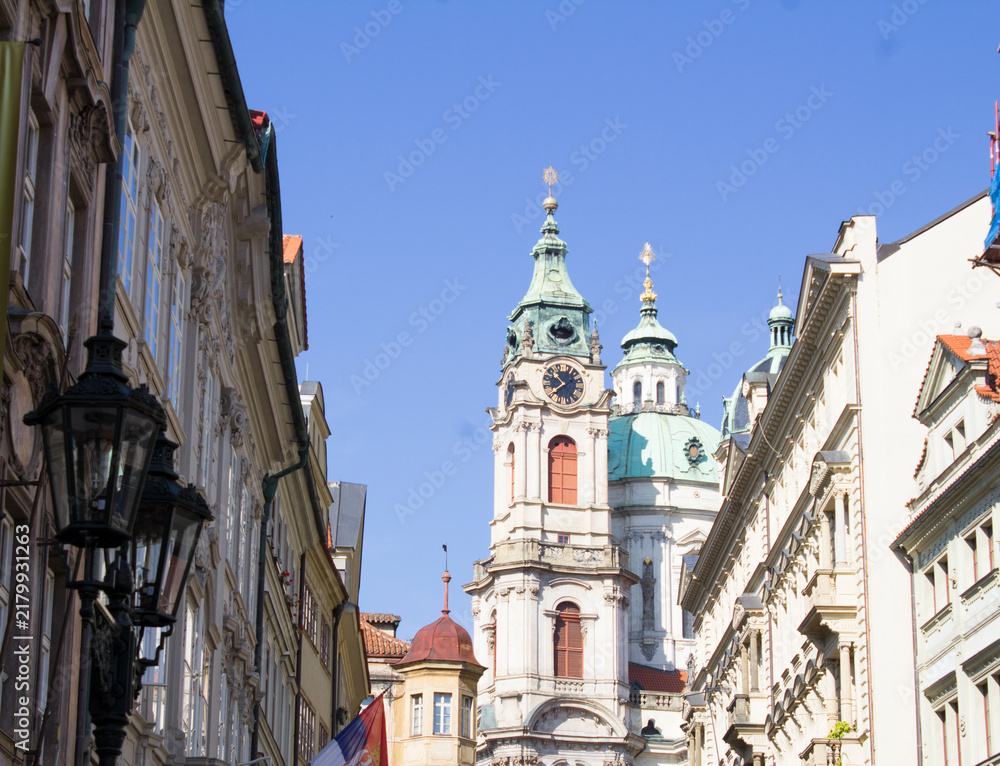 Fototapeta premium View of city street and Church of St. Nicholas in Prague. Czech Republic.