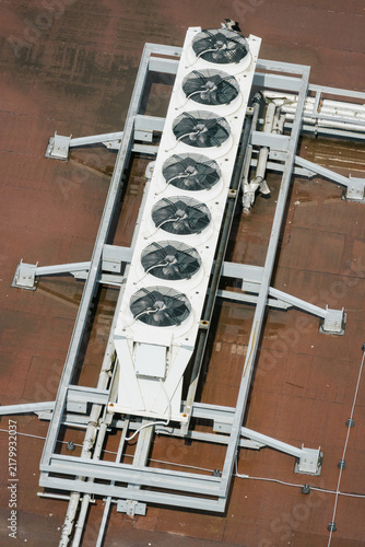 Industrial row of AC units on metal rooftop frame. Top view, technology.