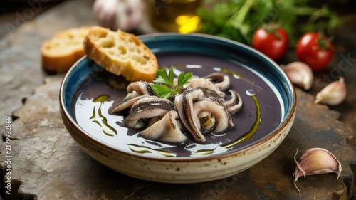 A national dish of Italian cuisine. 
Zuppa di seppie is a fish soup made from cuttlefish, which is prepared with the addition of their ink to give it a characteristic color and a marine flavor. 