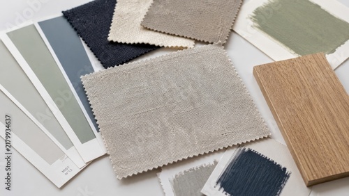 Fabric swatches paint chips and a wood sample on a white table