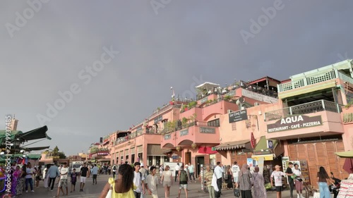 Marrakech, morocco. August 9, 2026. Bustling street scene in the vibrant jemaa el fnaa square in marrakech, morocco, with tourists and locals walking among the buildings