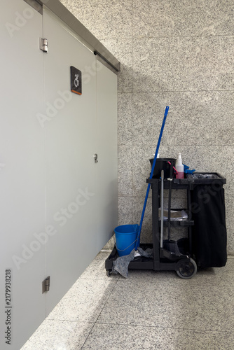 Cleaning cart next to public restroom stalls