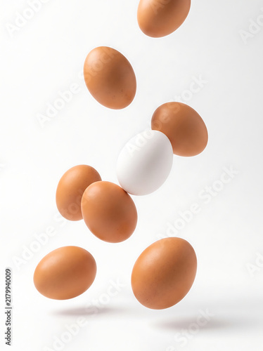 falling brown and white eggs